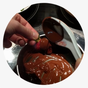 Holding A Strawberry By It's Stem, Use A Spoon To Ladle