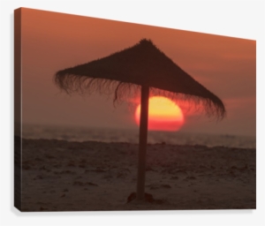 Silhouette Of A Beach Umbrella On The Beach With A