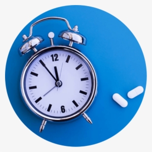Alarm Clock On A Blue Surface With Xanax Pills Beside - Pharmaceutical Drug