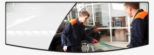 Repairmen Holding A Car Windshield For Replacement - Mandan Auto Glass