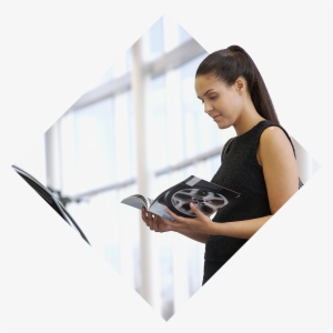 A Woman Standing In Car Dealership Reading A Brochure - Girl