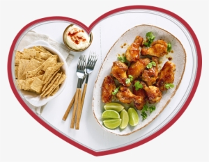 An Image Of Maple Glazed Chicken Wings In A Bowl With - Sesame Chicken
