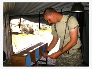 A Uniformed Man Places Mail Into Cardboard Boxes - Army Mail Man