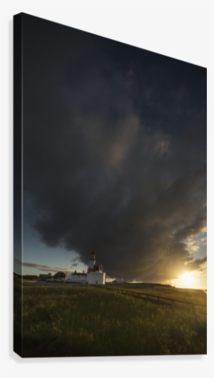 Storm Cloud Formation Over A Lighthouse At Sunset