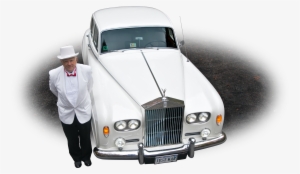 Photo Of A Chauffeur In Front Of A White 1964 Rolls-royce - Rolls-royce Corniche