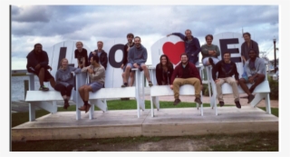 Group Of People Sitting On Over Sized Chairs With Love