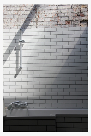 Bathroom With Bathtub Up Against The Old Facade Brick