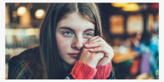 A Teenage Girl Looks Distressed At A Cafe - Adolescence