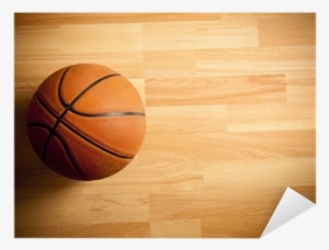 An Official Orange Ball On A Hardwood Basketball Court