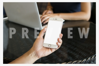 Female Hand Holding An Iphone With A Background Of - Iphone