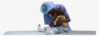 Photo Of Doctor Hugging Child Patient - Sitting